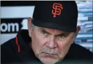  ?? GENE J. PUSKAR - THE ASSOCIATED PRESS ?? FILE - In this May 11, 2018 file photo, San Francisco Giants manager Bruce Bochy sits in the dugout before a game against the Pittsburgh Pirates in Pittsburgh.