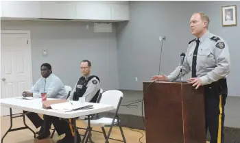  ??  ?? RCMP Detachment commander, Sergeant Tim Schwartz addresses community members at the Town Hall meeting.