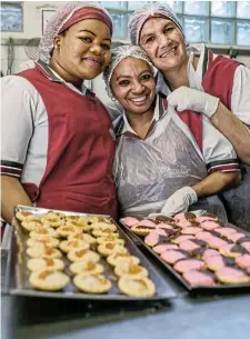  ?? Picture: Desmond ?? Martha Chaima, Kaltoena Barnard and Kashiefa Abrahams with their baked ‘hertzoggie­s’ on the left and ‘tweegevrie­tjies’ on the right.