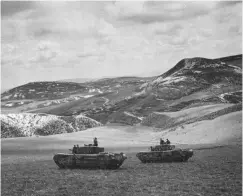  ?? ?? ■ Two Churchill tanks of the North Irish Horse pictured during the assault on Longstop Hill during April 1943. In the foreground is the tank Ballyrasha­ne with Bangor beyond. (ww2 Images)