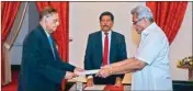  ?? ?? President Gotabaya Rajapaksa, right, hands over the appointmen­t document to Gamini Lakshman Peiris after he took oath of office as the new foreign minister in Colombo, Sri Lanka, on Saturday