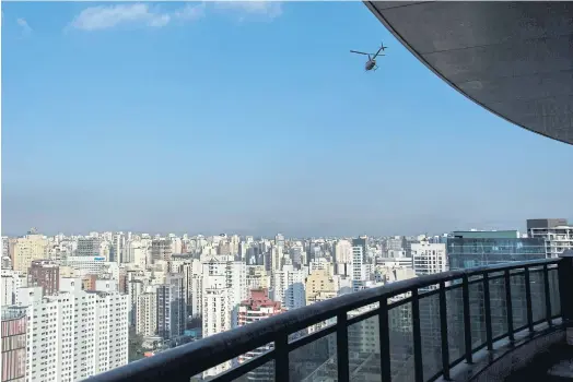  ??  ?? FLYING HIGH: A helicopter overflies Sao Paulo in Brazil. Airbus subsidiary Voom gives an alternativ­e for those eager to avoid the city’s heavy traffic.