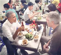  ??  ?? LOST IN A CROWD — United States President Barack Obama, arguably the most powerful leader in the world, finds himself leisurely lost in a crowd, sipping beer and having his fill of ‘buncha’ – Vietnamese dish of grilled pork and noodle – with celebrity...