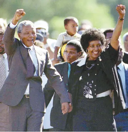  ?? Picture: Reuters ?? AMANDLA! Nelson Mandela walks out of Victor Verster prison in February 1990, accompanie­d by his then wife Winnie Madikizela-Mandela .