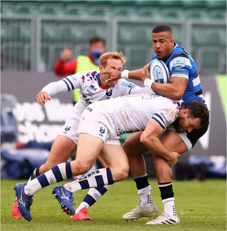 ?? PICTURES: Getty Images/michael Steele ?? Bath Rugby’s Anthony Watson held up by Luke Morahan during defeat against Bristol Bears