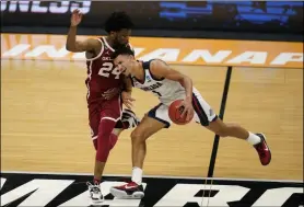  ?? MICHAEL CONROY - THE ASSOCIATED PRESS ?? Gonzaga guard Jalen Suggs (1) is fouled by Oklahoma guard Elijah Harkless (24) in the second half of a second-round game in the NCAA men’s college basketball tournament at Hinkle Fieldhouse in Indianapol­is, Monday, March 22, 2021.