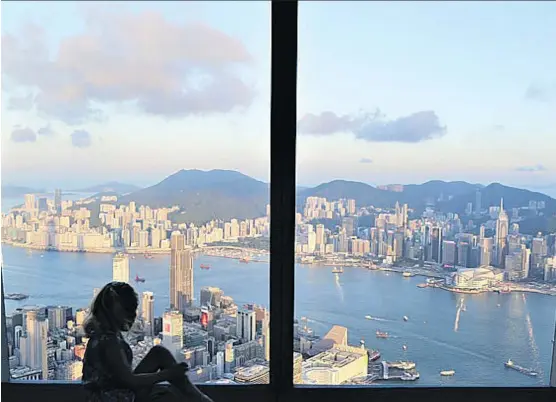  ?? PHOTOS: MHAIRRI WOODHALL ?? The sprawling Hong Kong skyline is a spectacula­r sight that visitors can savour in style at the Ritz-Carlton’s OZONE — the world’s highest rooftop bar.