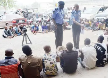  ?? Photo: NAN ?? FCT Police Commission­er, Sadiq Bello (centre) and the FCT Police Public Relations Officer, Anjuguri Manzah, parade some suspected criminals during the Monthly News Conference at the FCT Police Command in Abuja yesterday