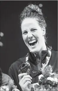  ?? ALBERT GEA / REUTERS ?? Missy Franklin of the US laughs as she poses with her gold medal after winning the women’s 200m backstroke at the world aquatics championsh­ips in Barcelona on Sunday.