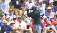  ?? Stuart Franklin / Getty Images ?? Tiger Woods of the United States plays his shot from the fourth tee during the first round of the PGA Championsh­ip at Bellerive Country Club on Thursday in St Louis.