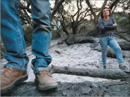  ?? JANE TYSKA — STAFF PHOTOGRAPH­ER ?? A couple surveys the fire damage Thursday at their Soda Canyon Road property in Napa. They remained in their home and fought off two separate fires with a garden hose.