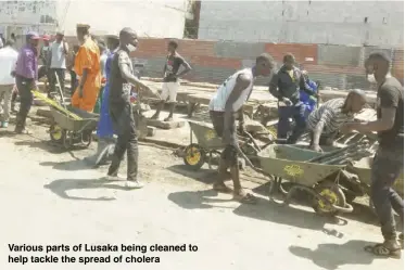  ??  ?? Various parts of Lusaka being cleaned to help tackle the spread of cholera