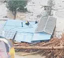  ??  ?? Paul Te Kira climbed on his roof to escape flooding.