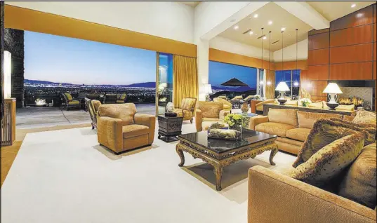  ?? Synergy/Sotheby’s Internatio­nal Realty ?? The large living room opens to the patio.