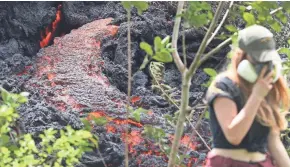  ?? MARIO TAMA/GETTY IMAGES ?? A resident of Hawaii’s Big Island walks past the lava flow from a new fissure in the Kilauea volcano in Pahoa, Hawaii.