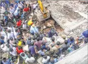  ??  ?? Rescue workers look for survivors in the debris at the site of a building collapse at Keshav Nagar in Mundhwa on Saturday.