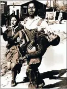  ?? Picture: SAM NZIMA ?? ICONIC PICTURE: Mbuyisa Makhubu carrying a dying Hector Pieterson in a picture that hit the news headlines all over the world. He has been missing for 25 years