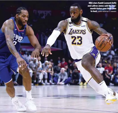  ?? HARRY HOW/GETTY IMAGES ?? NBA stars Kawhi Leonard (left) and LeBron James said the fourmonth hiatus gave them time to heal.