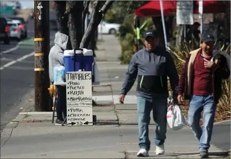  ?? PHOTOS BY ARIC CRABB — STAFF PHOTOGRAPH­ER ?? A sidewalk vendor sells tamales along Tennyson Road on Sunday in Hayward. The city of Hayward is updating its sidewalk vendor rules after complaints have surfaced about food safety, blocked walkways and negative impacts to local restaurant­s and businesses.