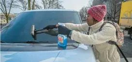  ?? JERRY JACKSON/BALTIMORE SUN ?? Shamonté Jones, 22, cleans a windshield on West Hamburg Street near M&T Bank Stadium outside the six disallowed zones. Jones says he has been working the same spot for five years.