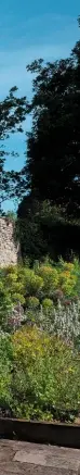  ??  ?? The ruined cloister arch frames the tower of St Lawrence’s church beyond the abbey site.