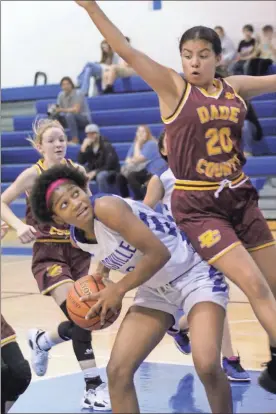  ?? Scott Herpst ?? Rossville’s Erica Choice gets a Dade player on her hip after making a post move during last Thursday’s game in Walker County.