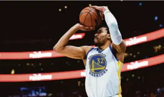  ?? Isaac Hale / Associated Press ?? Warriors forward Otto Porter Jr. had 20 points, seven rebounds and a career-high-tying eight assists to help Golden State withstand Utah in Salt Lake City on Saturday night.