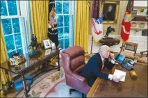 ?? DOUG MILLS / THE NEW YORK TIMES ?? President Donald Trump speaks on the phone in the Oval Office of the White House with a photo of his father, Fred C. Trump, behind him.The president has long sold himself as a self-made billionair­e, but a New York Times investigat­ion found that he received at least $413 million in today’s dollars from his father’s real estate empire, much of it through tax dodges in the 1990s.
