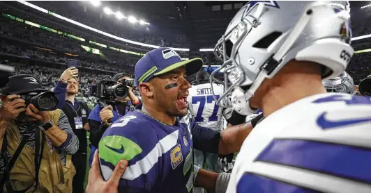  ?? Ronald Martinez / Getty Images ?? Russell Wilson, left, is said to be unhappy in Seattle and has expressed an interest in playing for the Cowboys, but Dallas isn’t expected to move on from Dak Prescott.