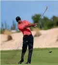  ??  ?? Tiger Woods is back putting his irons to the use for which they were intended.