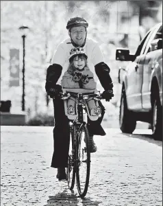  ?? DISPATCH ?? ERIC ALBRECHT Nathaniel Vogt of Columbus rides his 4-year-old daughter, Donna, to daycare after attending the Bike to Work event at Columbus Commons.