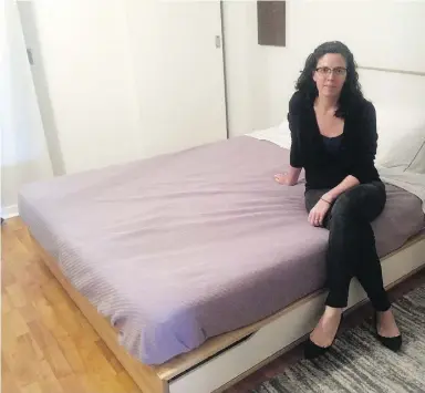  ?? COURTESY CORI CARL ?? Cori Carl sits on her bed in her Toronto apartment near Dundas Square. Her roommates listed it on Airbnb without her consent. She is a marketing consultant from New York City in the process of relocating to Toronto, and stays in the apartment roughly...