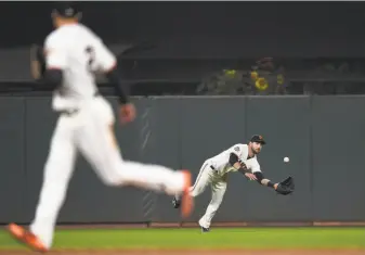 ?? Thearon W. Henderson / Getty Images 2018 ?? Steven Duggar dives for a ball against the Brewers last season. The Giants’ outfield is far from settled with Duggar, Mac Williamson, Austin Slater and Chris Shaw among the top candidates.