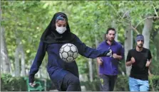  ?? REUTERS ?? Freestyle footballer Hosna Mirhadi, 23, wears a protective face mask and gloves as she trains at a park in Teheran, Iran, on Tuesday.