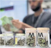  ?? JOHN LOCHER THE ASSOCIATED PRESS FILE PHOTO ?? Private cannabis stores will have to give up offering delivery and curbside pickup, which helped generate more business during the pandemic, despite a likely extension of emergency orders.