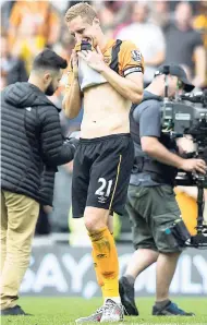  ??  ?? Hull City’s captain, Michael Dawson, leaves the pitch after his team is relegated from the English Premier League after their match against Manchester United at the KC Stadium, Hull, England, yesterday.