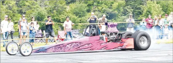  ?? Westside Eagle Observer/MIKE ECKELS ?? Drag racer Alexis Campbell burns rubber just before her run down the runway at Crystal Lake Airport during the Exotic Experience Car Show in Decatur June 15. The 17-yearold Campbell is in her second year of drag racing.