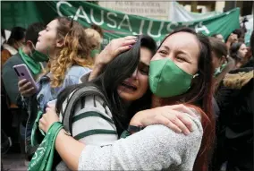  ?? AP PHOTO/FERNANDO VERGARA, FILE ?? FILE - Abortion-rights activists celebrate after the Constituti­onal Court approved the decriminal­ization of abortion, lifting all limitation­s on the procedure until the 24th week of pregnancy, in Bogota, Colombia, Monday, Feb. 21, 2022. Colombia, where the Constituti­onal Court in February legalized abortion until the 24th week of pregnancy, is part of a broader trend seen in parts of heavily Catholic Latin America.