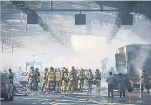  ?? AFP ?? Firefighte­rs work at the scene of a fire in an expressway tunnel in Gwacheon on the outskirts of Seoul yesterday after a bus and truck crash caused a huge fire.