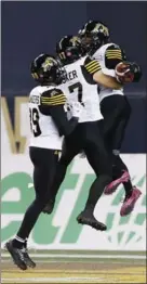  ?? JOHN WOODS, THE CANADIAN PRESS ?? From left, Hamilton Tiger-Cats’ Jalen Saunders, Luke Tasker and Brandon Banks celebrate Banks’ touchdown in their win over Winnipeg. DREW EDWARDS