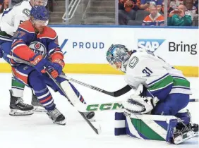  ?? PERRY NELSON/USA TODAY SPORTS ?? The Oilers’ Warren Foegele looks for a loose puck in front of Canucks goaltender Arturs Silovs.