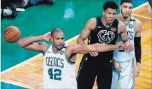  ?? MICHAEL DWYER THE ASSOCIATED PRESS ?? Celtics’ Al Horford and Milwaukee Bucks’ Giannis Antetokoun­mpo react to a call during the fourth quarter of Game 1 in Boston.