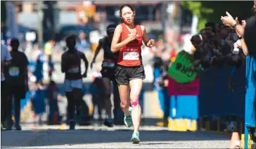  ?? PHOTO: RICHARD LAM / RUNVAN® ?? China’s Zhiling Zheng becomes the first-ever Chinese winner at the Vancouver Marathon.