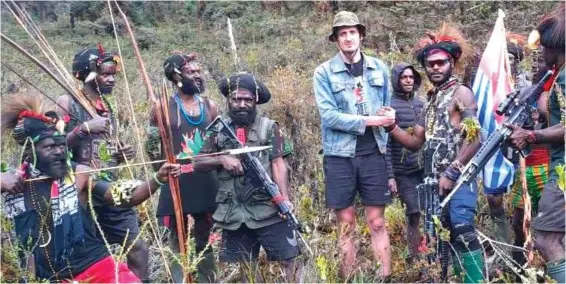  ?? ?? Held hostage: Phillip Mehrtens is surrounded by West Papua Liberation Army fighters in a video they shared from Nduga, Indonesia