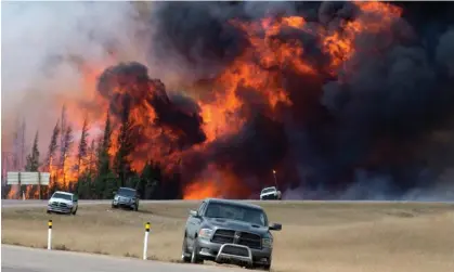  ?? ?? A wildfire burns south of Fort McMurray, Alberta, near Highway 63 on 7 May 2016. Photograph: Jonathan Hayward/AP