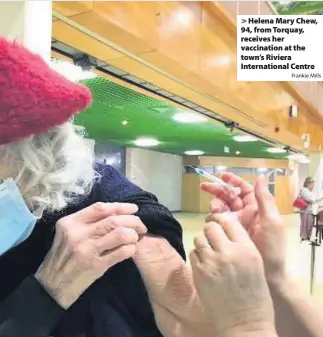  ?? Frankie Mills ?? Helena Mary Chew, 94, from Torquay, receives her vaccinatio­n at the town’s Riviera Internatio­nal Centre