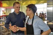  ?? GENE SWEENEY JR. / GETTY IMAGES ?? Candidate for Senate Mitt Romney (left) visits Cafe Zupas in Provo, Utah, on Friday. Romney is running for the seat currently held by Sen. Orrin Hatch, who plans to retire after his term expires.