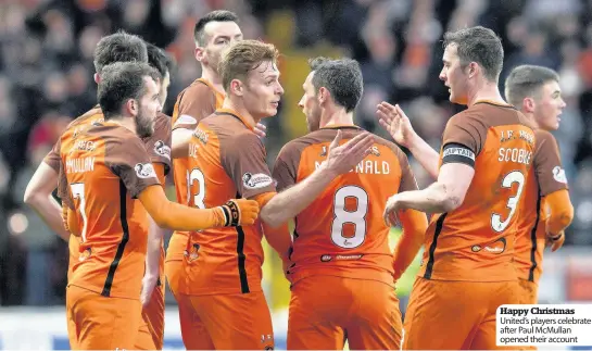  ??  ?? Happy Christmas United’s players celebrate after Paul McMullan opened their account