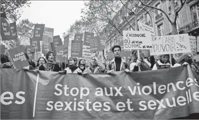  ?? AGENCE FRANCE-PRESSE ?? Participan­ts walk with a banner reading “Stop sexist and sexual violence” as they take part in a rally in Paris on Saturday, marking the Internatio­nal Day for the Eliminatio­n of Violence against Women.