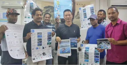  ?? Photo: WWF Pacific/Ravai Vafo’ou ?? Sunshine Fisheries crew with their General Manager Darren Zhang and fishing crew receiving their by-catch awareness materials for vessels.